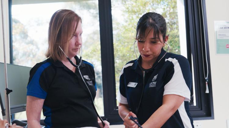 Nursing student with trainer